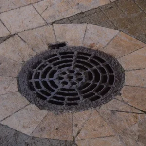 Patio paving with a round drain grate