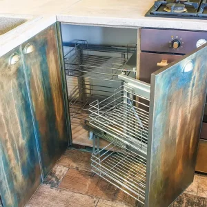 Outdoor kitchen with open cabinet and pull-out wire shelves
