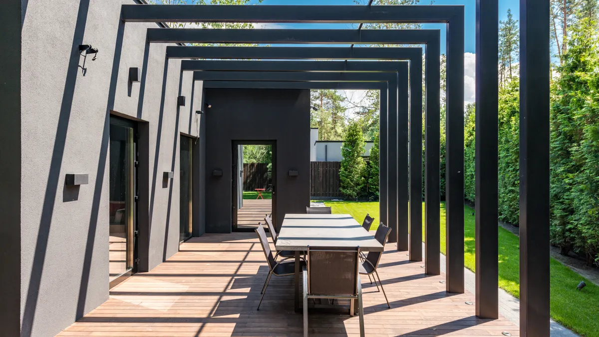 Outdoor kitchen shade options: pergolas, roofs, and umbrellas Modern pergola frame over an outdoor dining space
