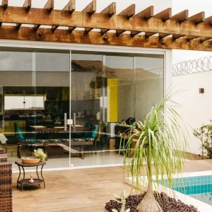 Attached pergola shading a poolside patio